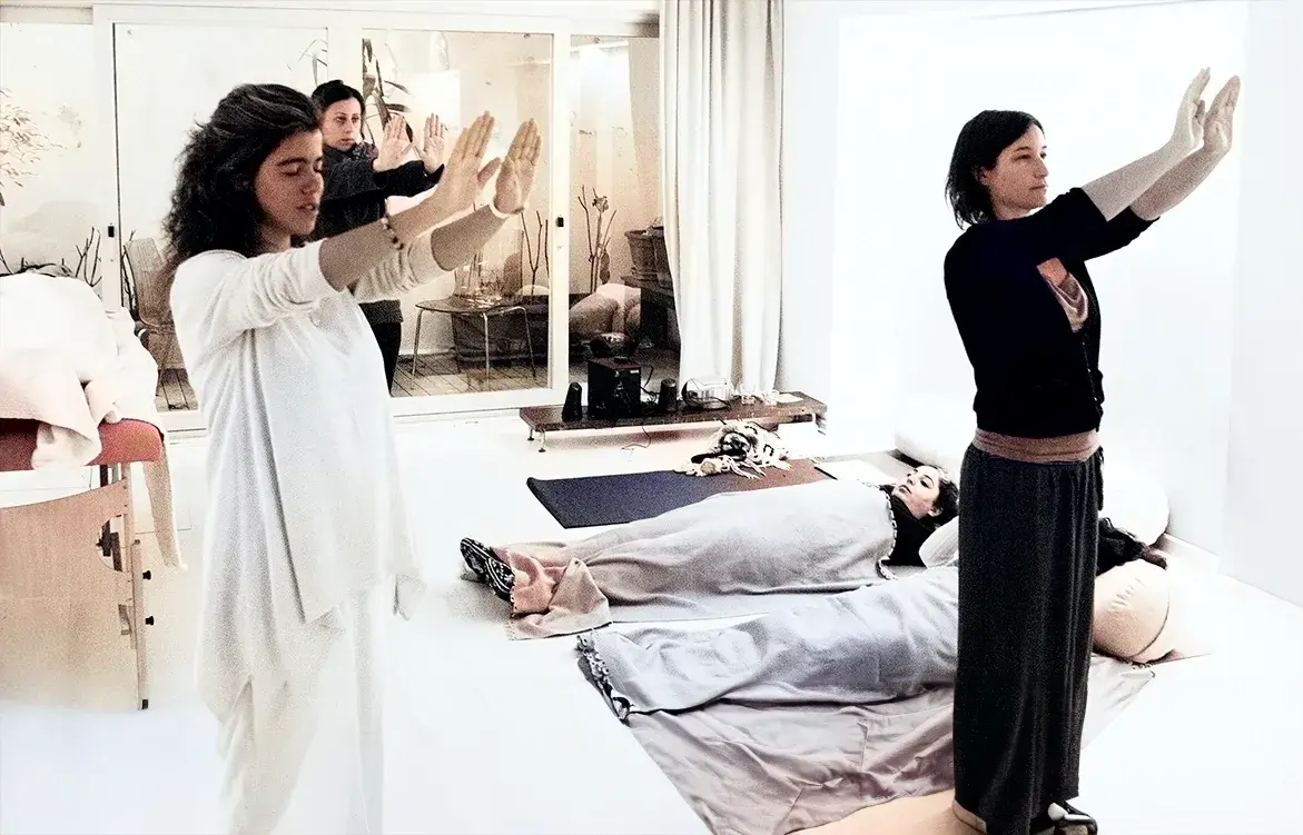 Reiki attunement ceremony during a Reiki course in Istanbul, teacher standing with raised hands.