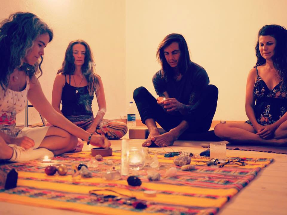 Hande Özerden y los participantes sentados alrededor de cristales y velas en un círculo de sanación con sonido.