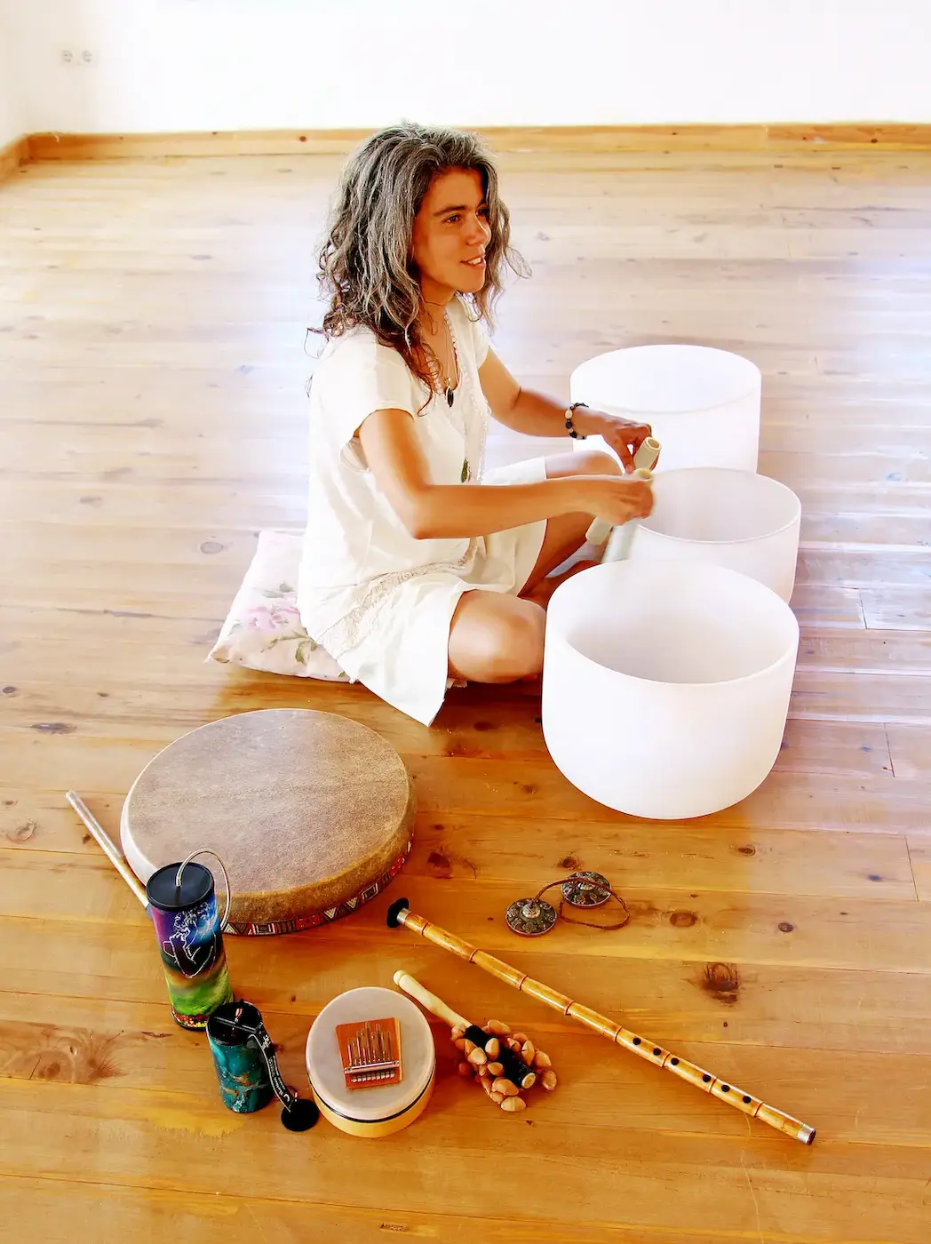 Hande Özerden, who gives sound healing sessions in London, playing quartz crystal bowls.