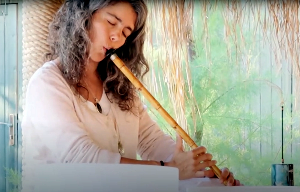 Eyes closed, Hande Özerden plays the ney, one of the instruments in her sound healing sessions in London.